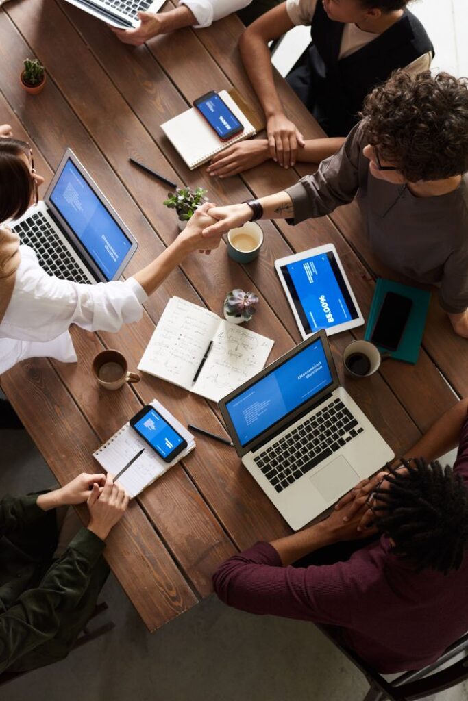 pexels photo 3183148 3183148 A diverse group of professionals brainstorming in a modern workspace with laptops and notebooks.