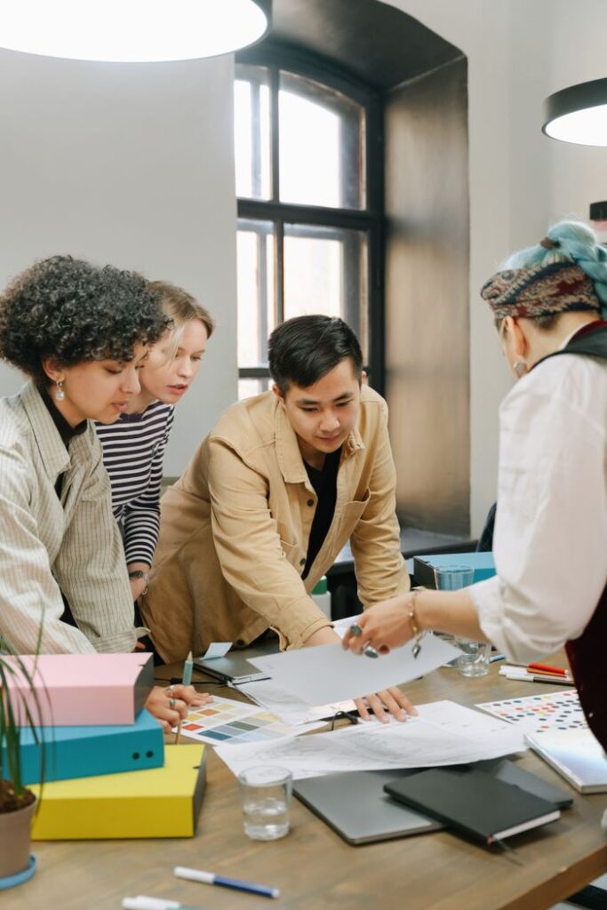 pexels photo 8117476 8117476 A diverse team engaged in a collaborative meeting in a modern office setting.